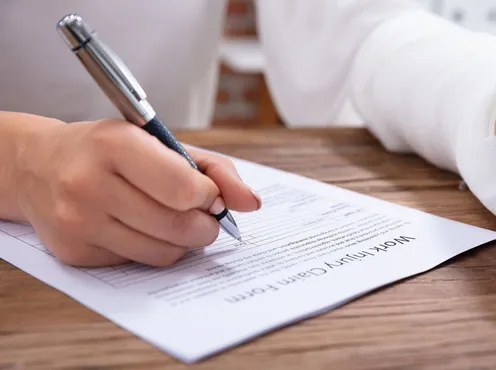 Person filling in a work injury claim form
